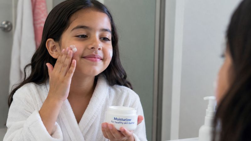 Child applying moisturizer for soft and hydrated skin